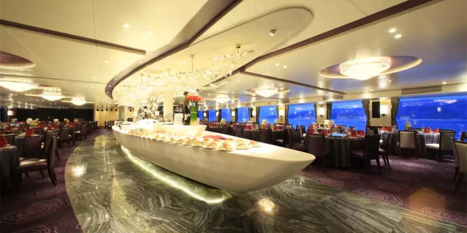 Toward the stern, the main restaurant welcomes guests for delicious meals and lively conversation, making it a popular gathering spot.