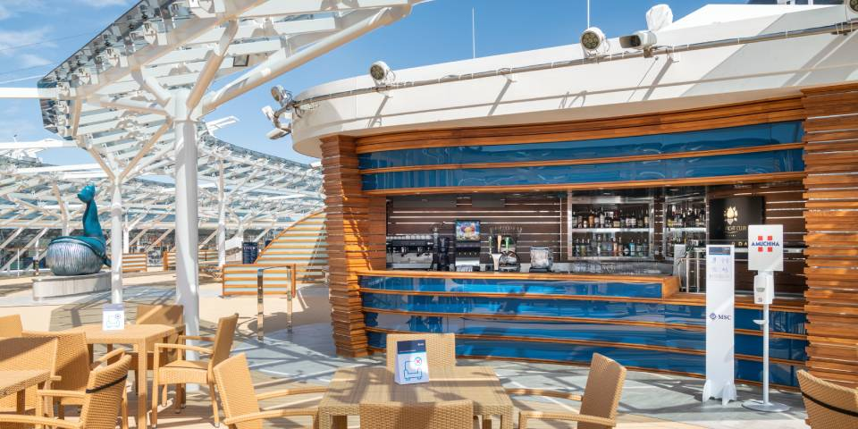 The MSC Yacht Club Grill & Bar is a dedicated outdoor terrace where guests can savour meals and drinks all day long.